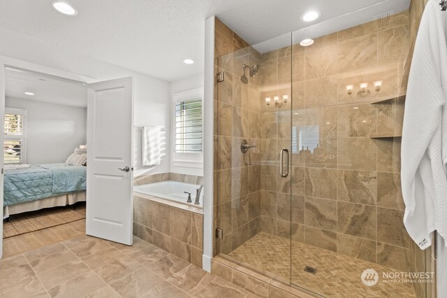 bathroom with hardwood / wood-style floors, a textured ceiling, and independent shower and bath