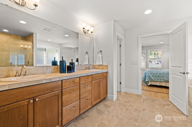 bathroom with vanity, a shower with shower door, and a textured ceiling