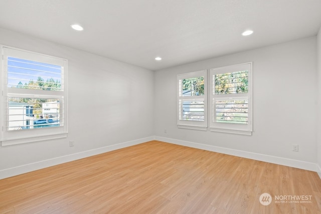 unfurnished room with light hardwood / wood-style flooring and a wealth of natural light