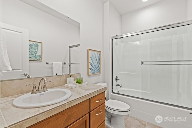 full bathroom featuring tile patterned floors, vanity, toilet, and enclosed tub / shower combo