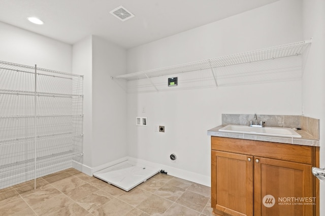 clothes washing area featuring hookup for an electric dryer, washer hookup, cabinets, sink, and hookup for a gas dryer