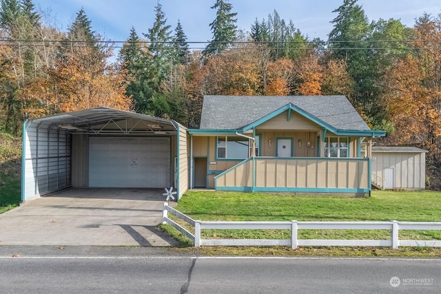 view of front of property with a front lawn, an outbuilding, a carport, covered porch, and a garage