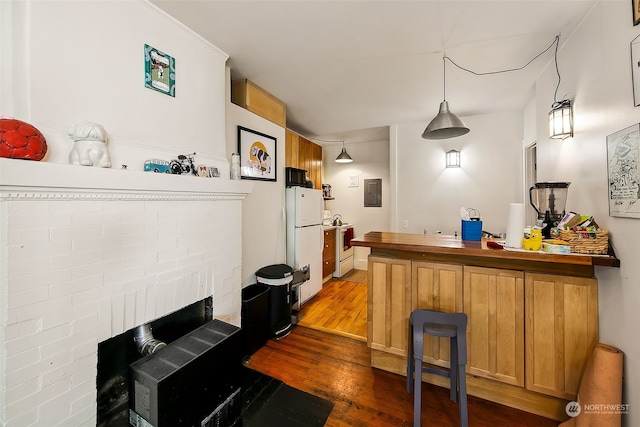 bar with electric panel, white fridge, pendant lighting, hardwood / wood-style floors, and a brick fireplace