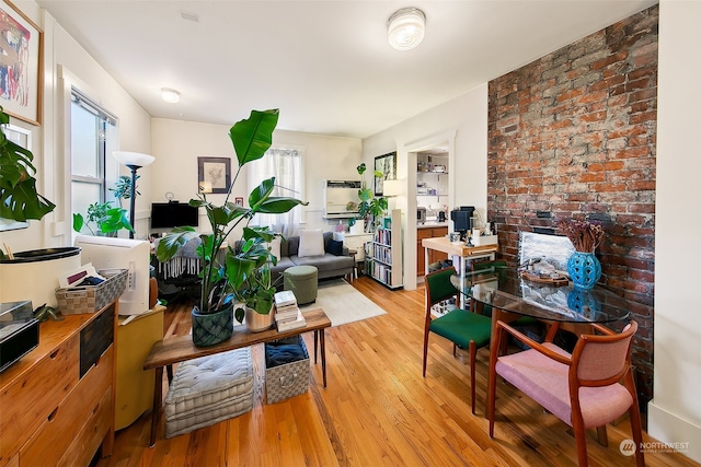 living room with light hardwood / wood-style floors and a healthy amount of sunlight