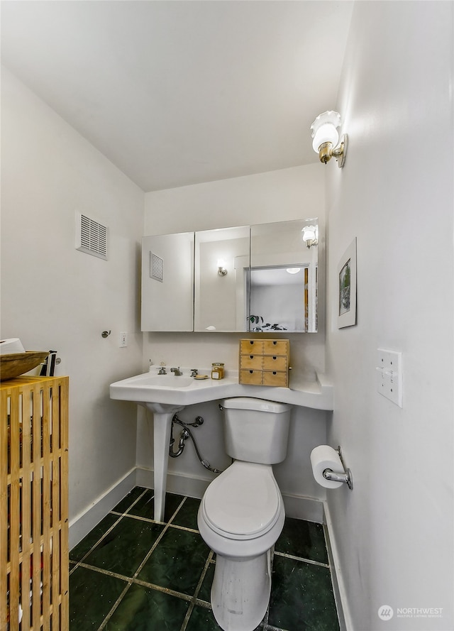 bathroom with tile patterned floors and toilet