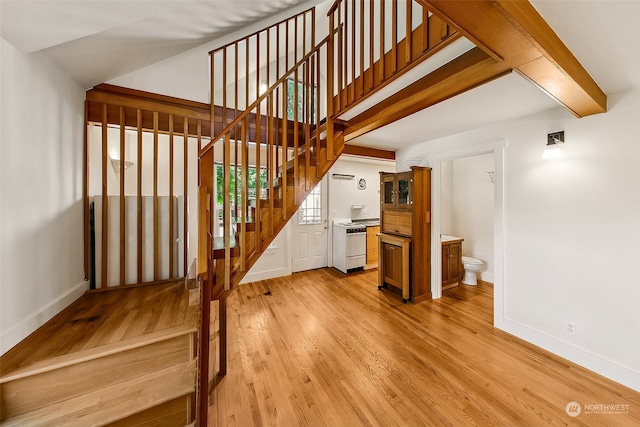 staircase with hardwood / wood-style flooring