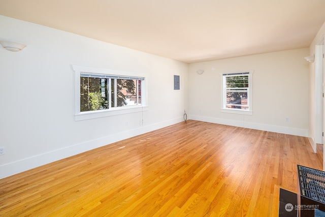 unfurnished room featuring hardwood / wood-style floors and electric panel