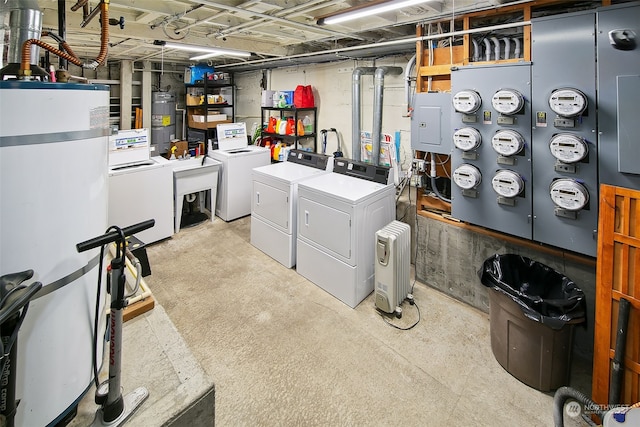 laundry room featuring electric water heater, electric panel, and independent washer and dryer