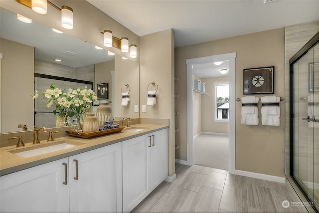 bathroom with a shower with door and vanity