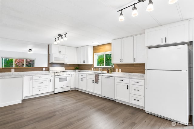 kitchen featuring sink, white appliances, light stone counters, white cabinets, and dark hardwood / wood-style flooring