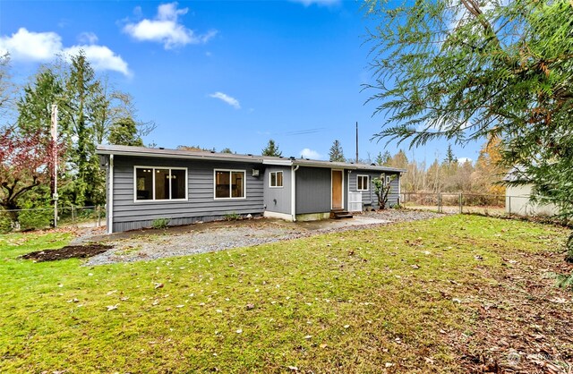 rear view of property with a yard