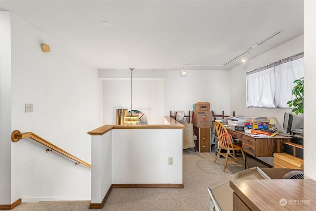 home office featuring light carpet and track lighting