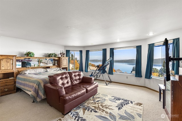 bedroom featuring light carpet and a water view