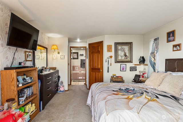 carpeted bedroom featuring ensuite bath