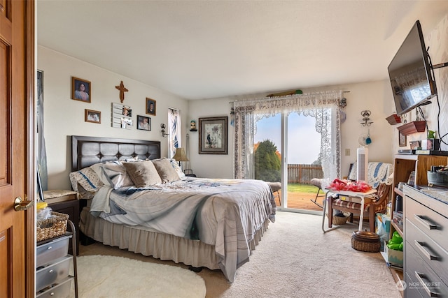 carpeted bedroom with access to outside