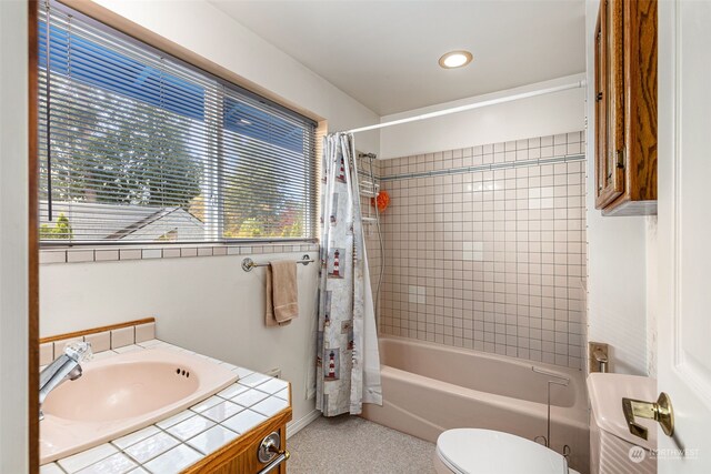 full bathroom featuring shower / bath combo, toilet, and vanity