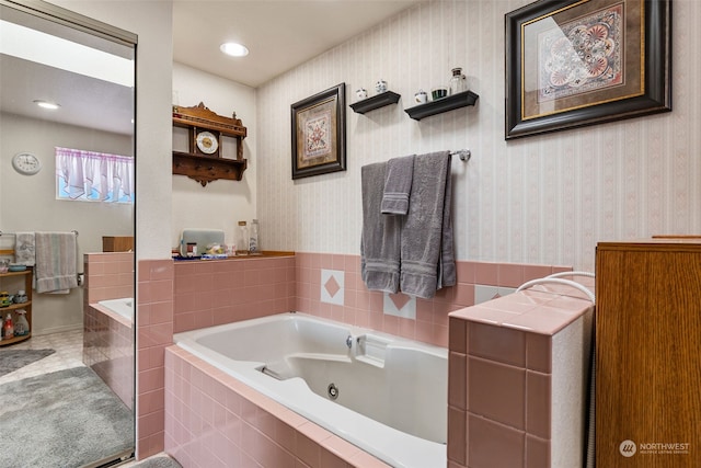 bathroom featuring a relaxing tiled tub