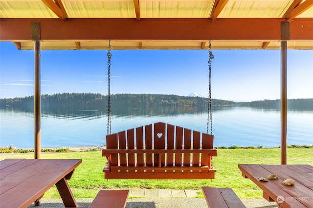 dock area with a water view and a lawn