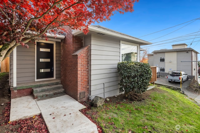 entrance to property with a yard