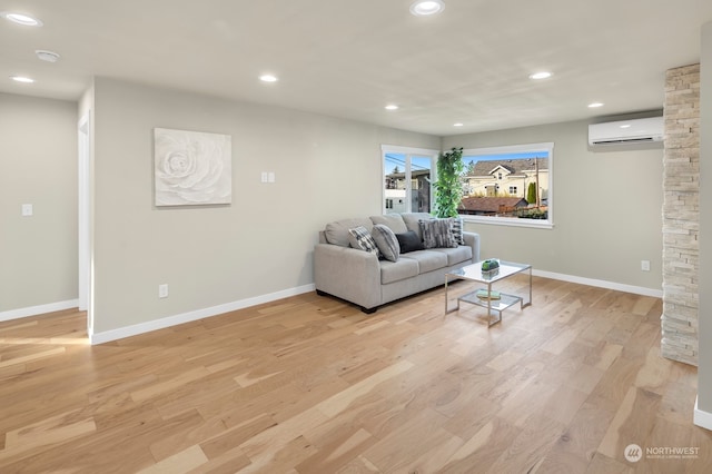 living room featuring light hardwood / wood-style floors and a wall mounted air conditioner