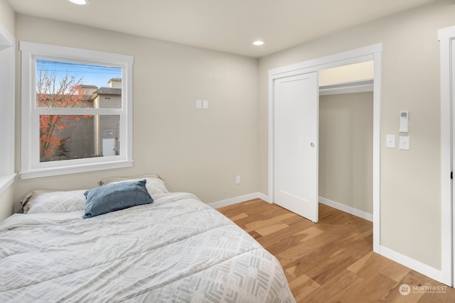 bedroom featuring a closet and light hardwood / wood-style flooring