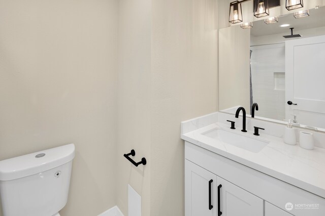 bathroom with vanity and toilet