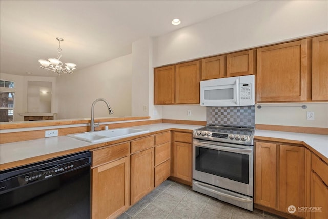 8906 123rd Ln NE, Kirkland, WA 98033 - kitchen with white microwave, stainless steel electric range, black dishwasher, a sink, and a chandelier