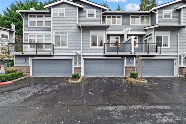 8906 123rd Ln NE, Kirkland, WA 98033 - townhome / multi-family property featuring brick siding, an attached garage, and driveway