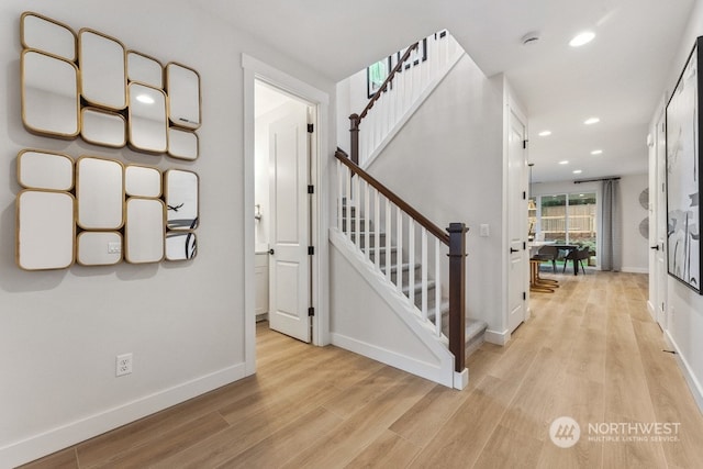 staircase featuring recessed lighting, baseboards, and wood finished floors