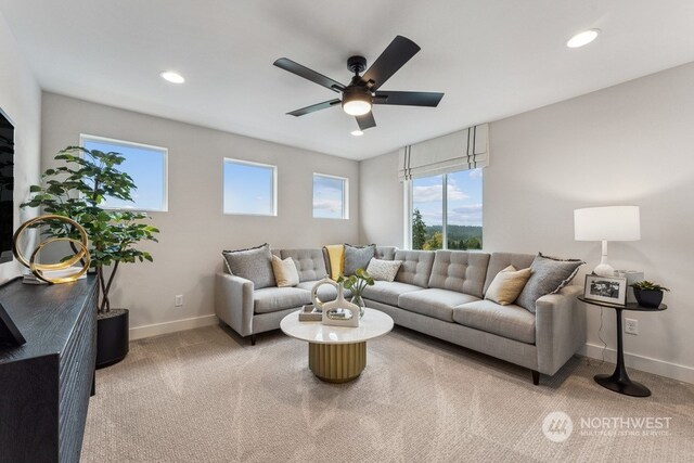 living area with recessed lighting, baseboards, light colored carpet, and ceiling fan