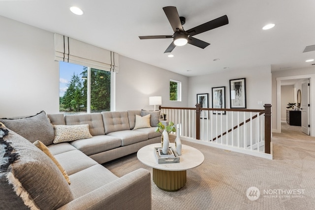 living area with visible vents, recessed lighting, light colored carpet, and ceiling fan