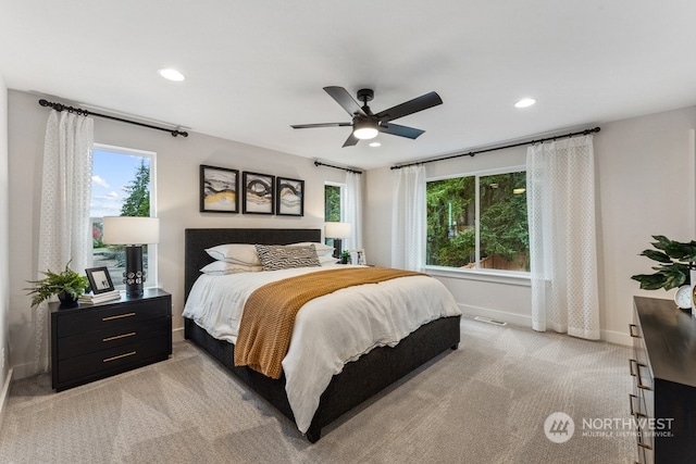 bedroom with light carpet, recessed lighting, baseboards, and ceiling fan