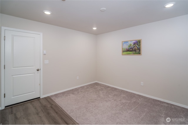 spare room featuring dark wood-type flooring