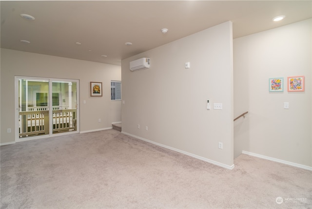 empty room with light carpet and a wall mounted air conditioner