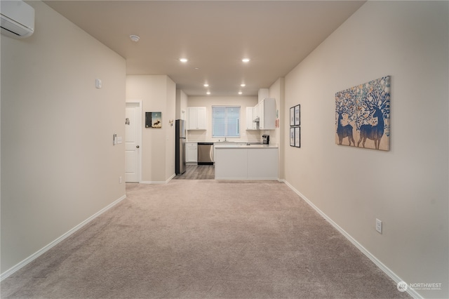 hallway with an AC wall unit and light colored carpet