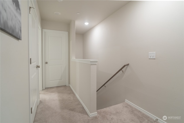 hallway featuring light carpet