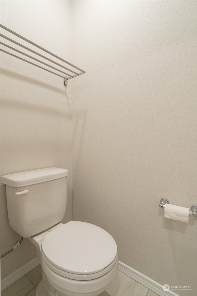 bathroom with tile patterned floors and toilet