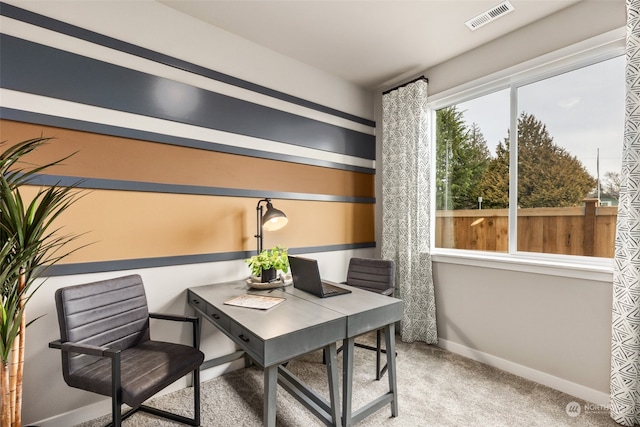 office area with baseboards, visible vents, and light colored carpet