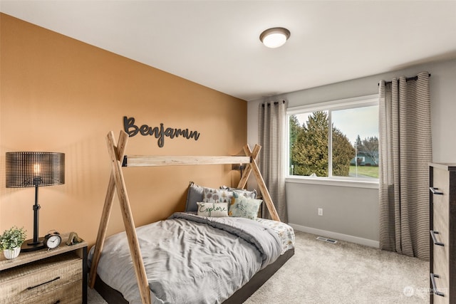 carpeted bedroom with visible vents and baseboards