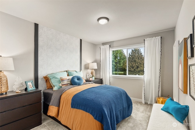 bedroom with light carpet and baseboards