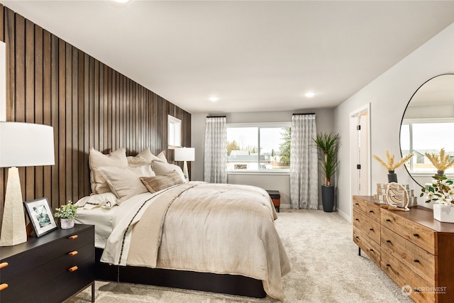 bedroom featuring light colored carpet and baseboards