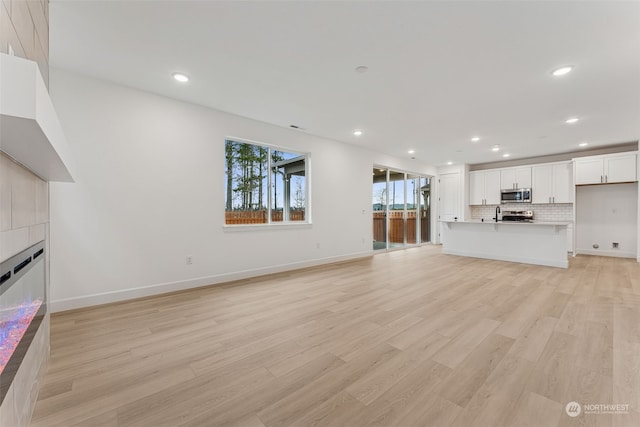 unfurnished living room featuring light hardwood / wood-style flooring