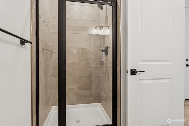 bathroom with a shower with door