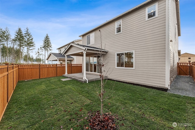 rear view of house with a patio area and a yard