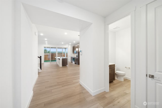 hall with light hardwood / wood-style flooring