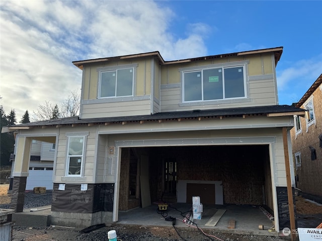 rear view of house featuring a garage