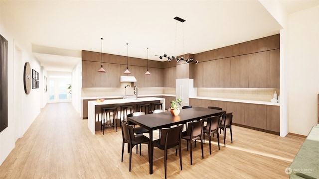 dining space with sink and light hardwood / wood-style flooring