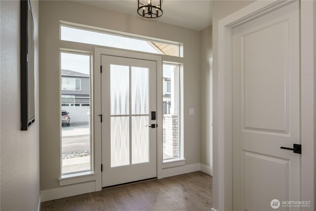 25708 64th Avenue Ct E Unit 4, Graham, WA 98338 - entrance foyer with wood finished floors, a chandelier, and baseboards