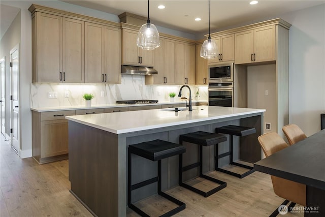 25708 64th Avenue Ct E Unit 4, Graham, WA 98338 - kitchen with oven, a sink, built in microwave, under cabinet range hood, and light wood finished floors