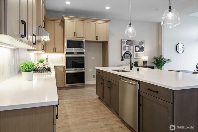 25708 64th Avenue Ct E Unit 4, Graham, WA 98338 - kitchen featuring appliances with stainless steel finishes, under cabinet range hood, light countertops, light wood finished floors, and recessed lighting